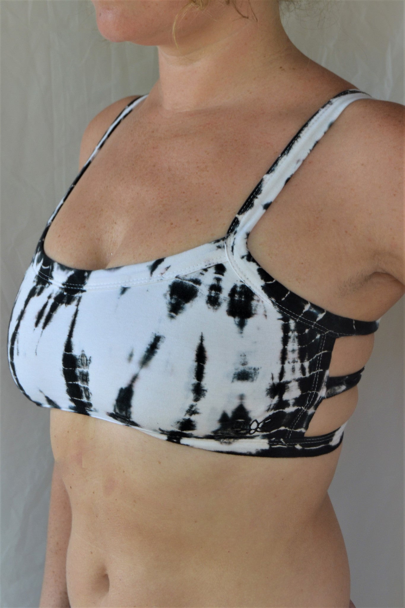 White with black tie dye sportsbra with three horizontal straps across the back. Incredibly comfortable with lighter support. Super soft 90% cotton 10% spandex
