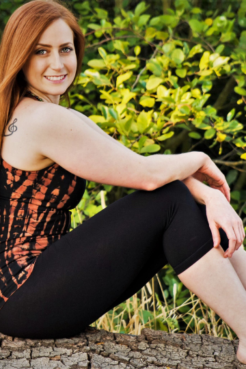 Solid colored black 3/4 length Yoga Pants have a fold over waist that is adjustable to fit a longer torso or be worn lower on the hips. Soft 90% cotton and 10% spandex shown with Fire tie dye Fitness Tank.