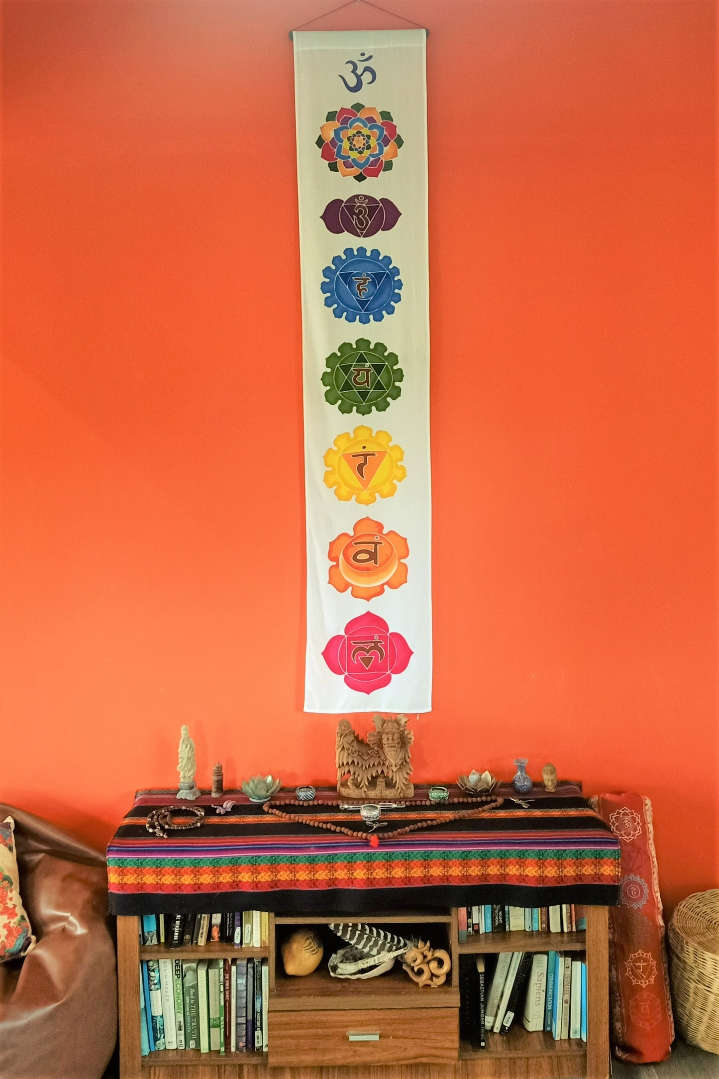 Vertical home decor wall hanging with white background and 7 rainbow colors chakra symbols. Handmade with wax and dye batik process on rayon fabric. Ready to hang.