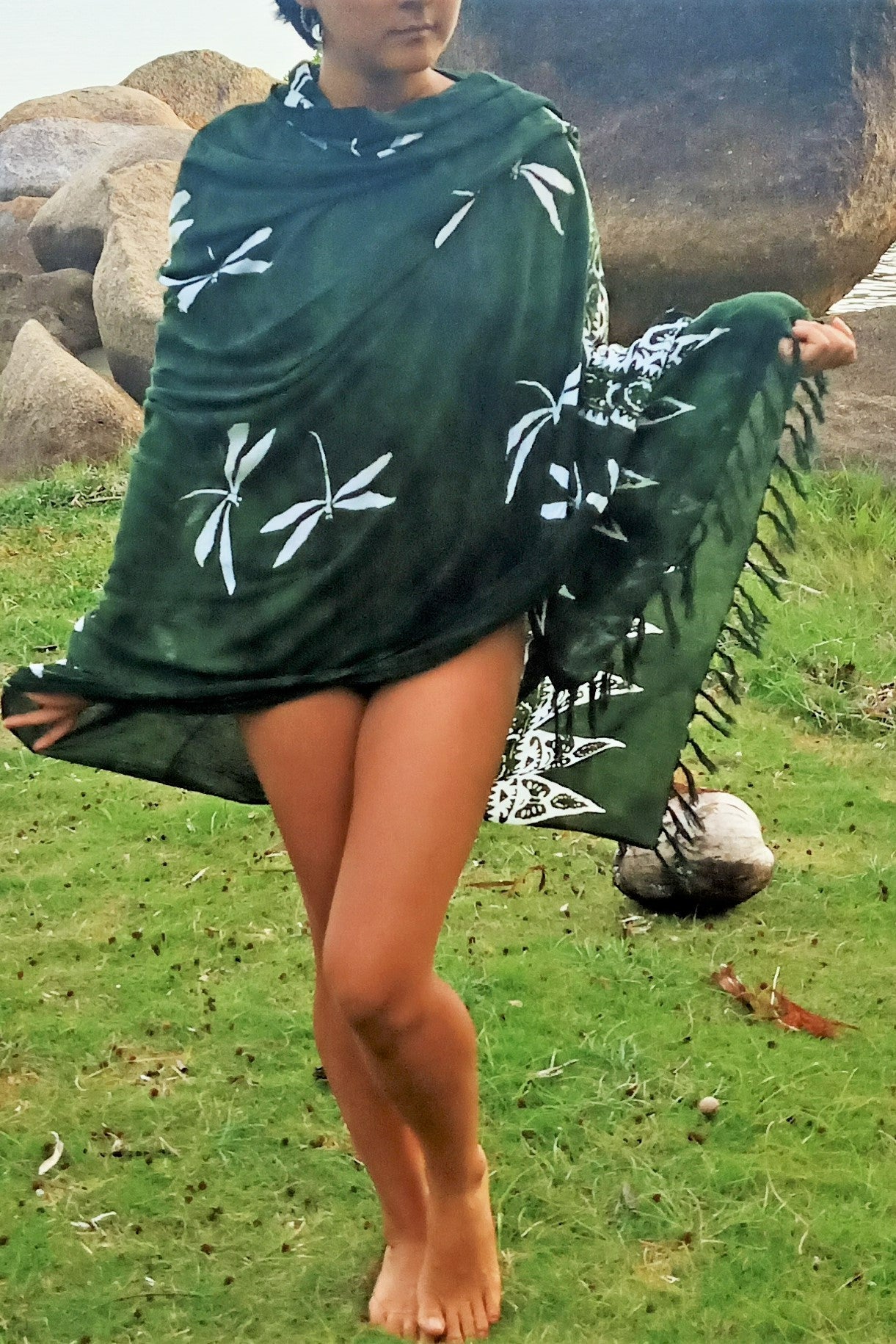 Green sarong with white dragonflies worn as a shall, beach cover up, scarf.
