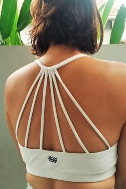 Stunning back straps design on crisp white Shakti sportsbra with small black lotus flower embroidery. Made of 90% cotton with 10% spandex. Comfortable, cute, functional and flattering.