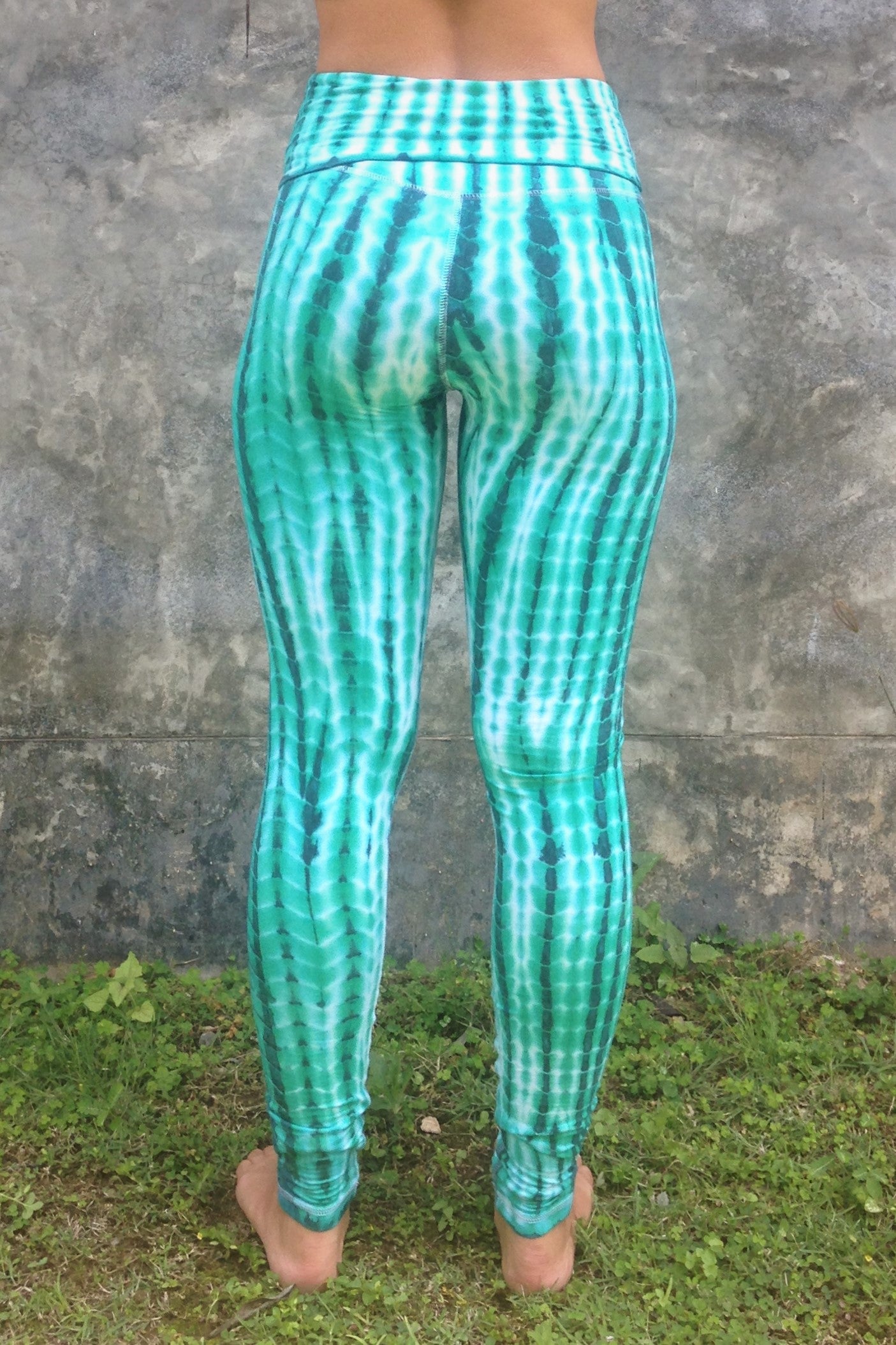 Long length yoga pants turquoise/teal tie dye. Fold over top for adjustable fit can be worn with higher waist or lower on the hips. 90% cotton 10% spandex. back view