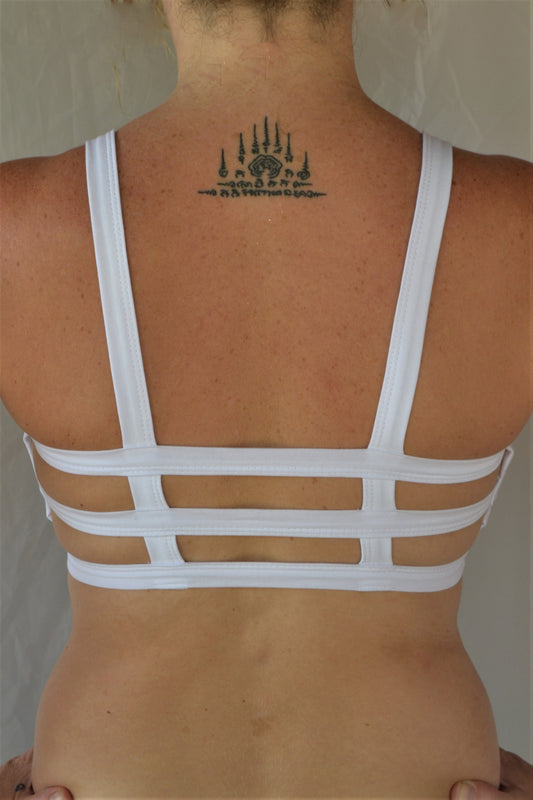 Crisp solid white, super comfortable sports bra, with 3 horizontal straps across back with black Lotus Flower embroidery in black on side 90% cotton 10% spandex