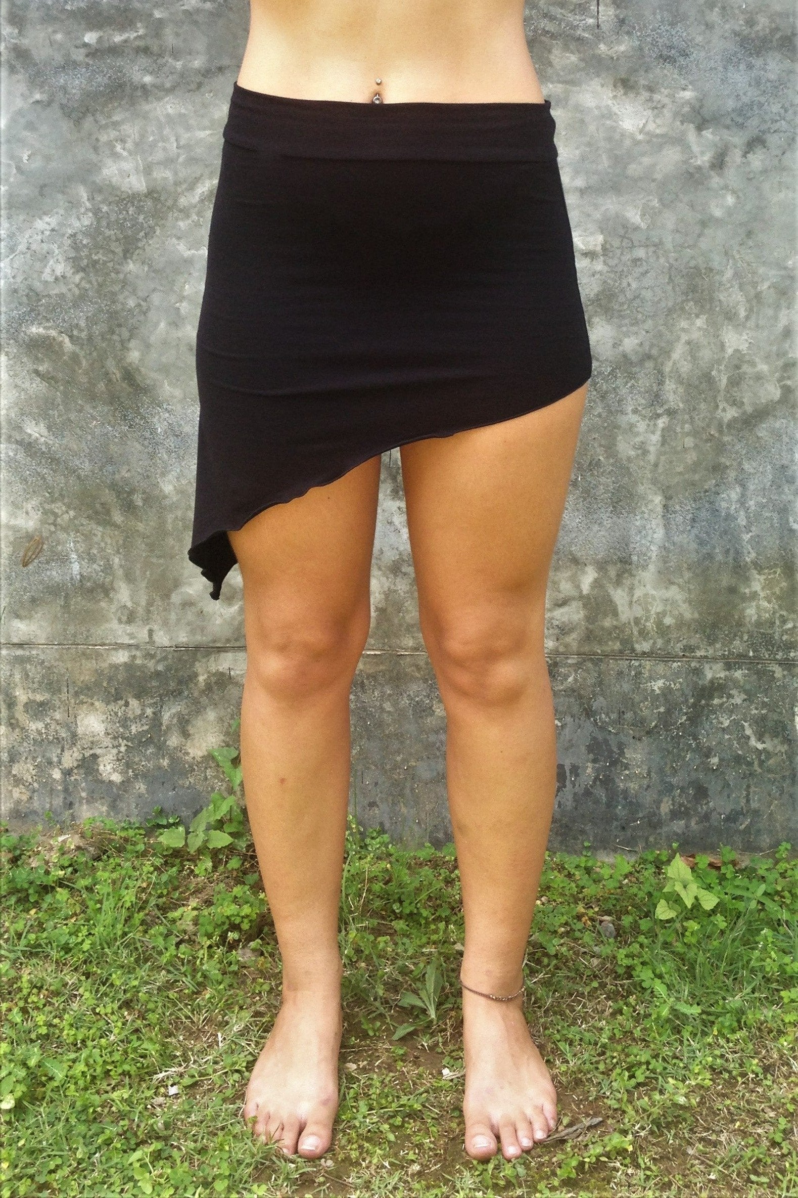 Front view of Festival Skirt by Lotus Tribe Clothing is a stretchy asymmetrical, easy to wear comfortable mini skirt. Looks great over bare legs or can be layered with leggings in cool er weather. Fold the top over or wear high waisted, custom form fits to your body shape. Soft and stretchy 90% cotton knit with 10% spandex. 
