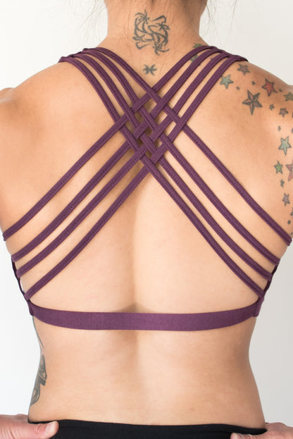 Plum colored sports bra with gold lotus flower design on front that has 4 criss cross straps in back and has enough support for down dog and other yoga poses. 90% cotton 10% spandex 
