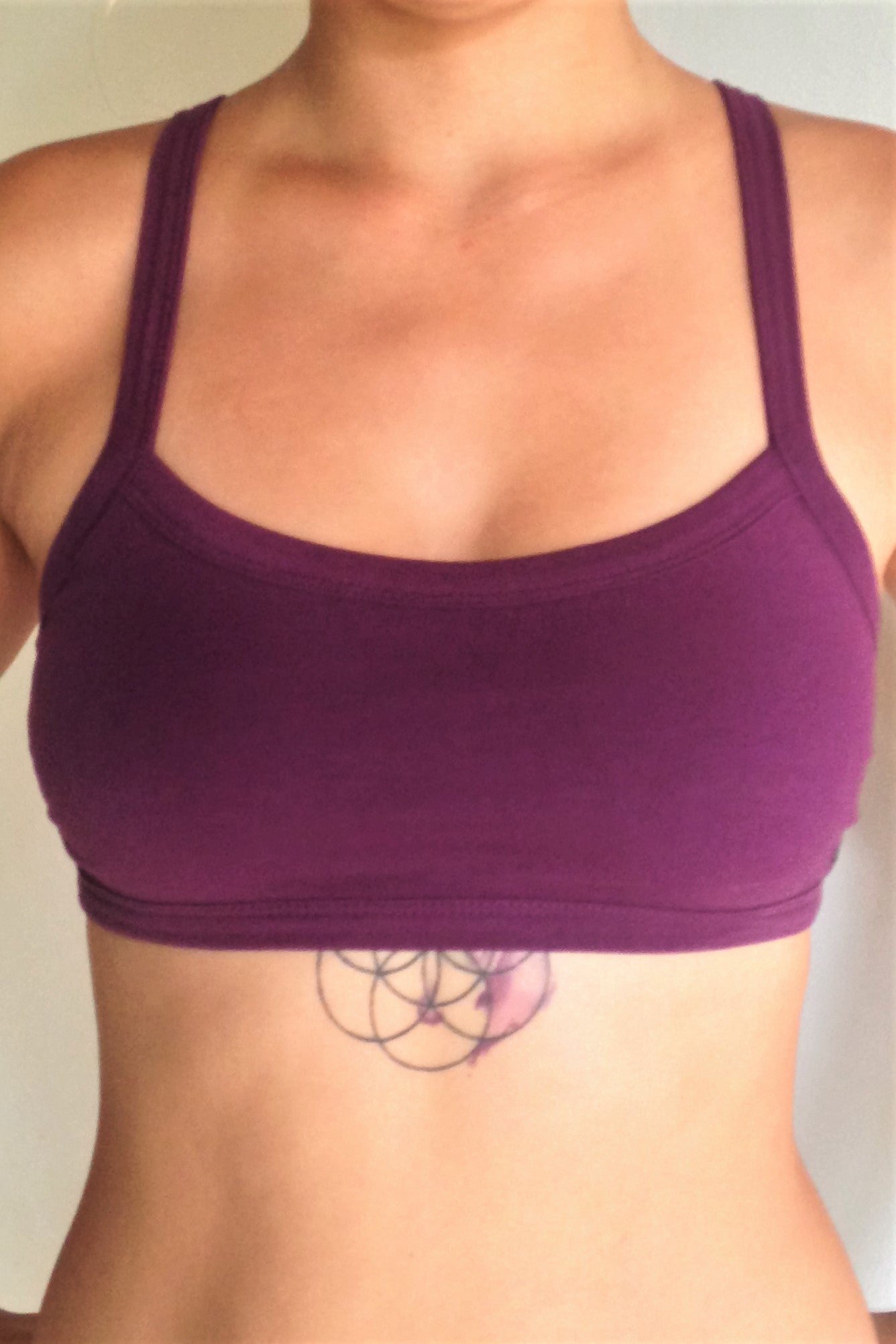 Front view of solid Plum colored Trinity Sportsbra, One of the most comfortable sports bras you will ever wear, soft and super cute. Solid purple front with 3 horizontal straps across back 90% cotton 10% spandex 
