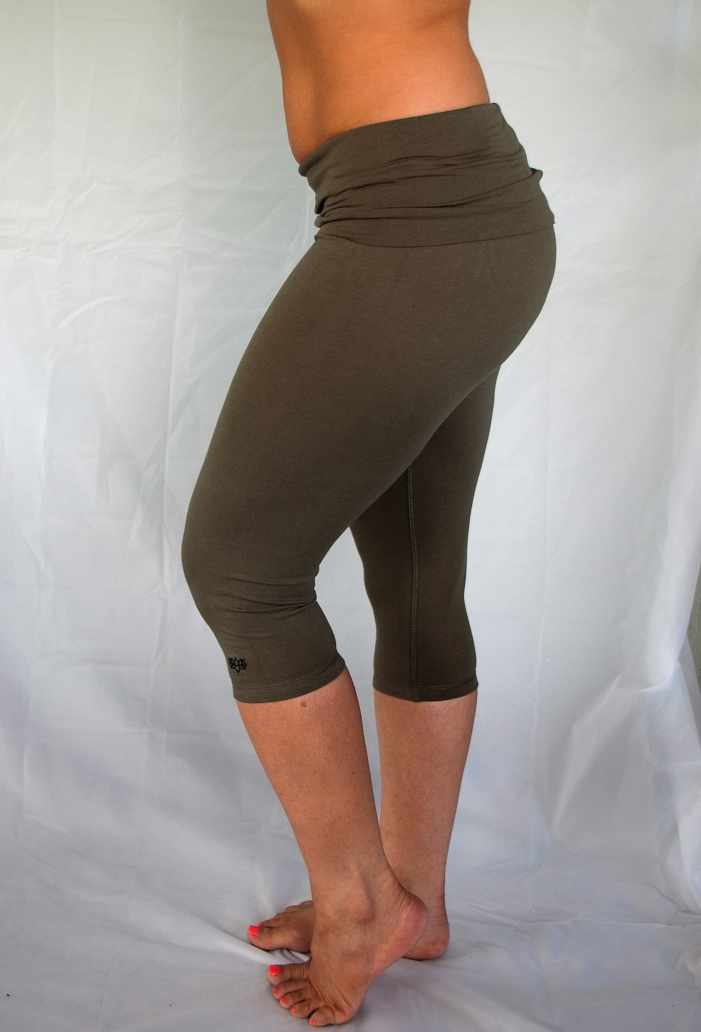 Solid colored sage green 3/4 length Yoga Pants have a fold over waist that is adjustable to fit a longer torso or be worn lower on the hips. Soft 90% cotton and 10% spandex.