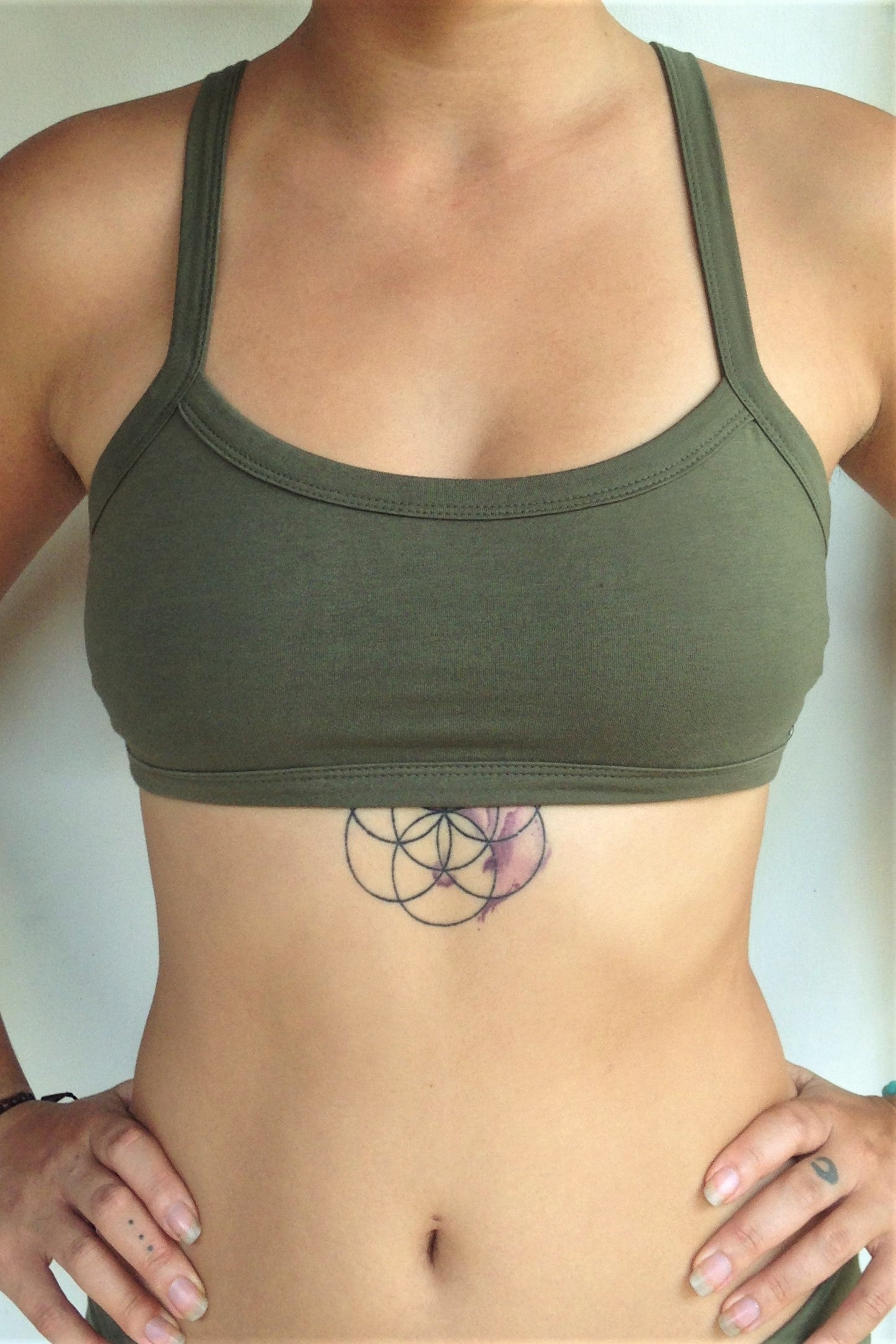 Front view of Trinity Sportsbra has solid Sage green front. One of the most comfortable sports bras you will ever wear, soft and super cute with 3 horizontal straps across back. Medium support.